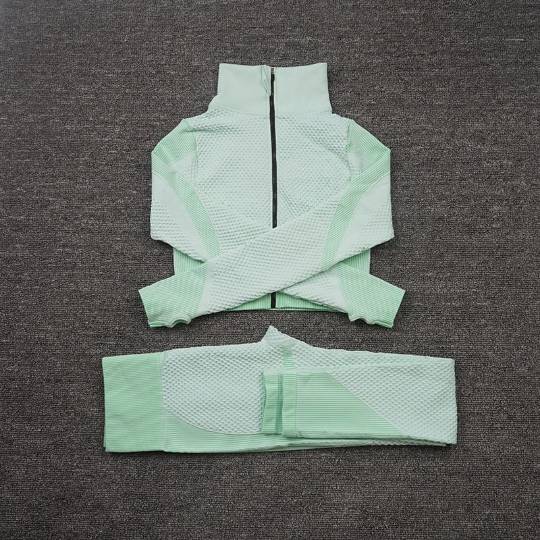 Women’s seamless fitness set with high-waisted sculpting leggings and long sleeve zip top.